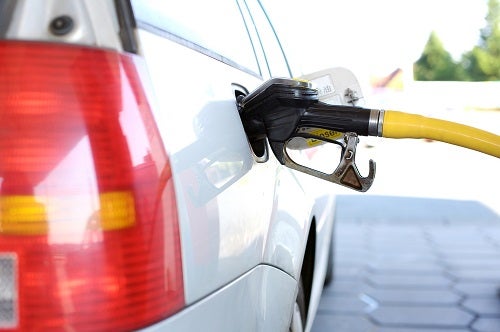 A gasoline pump filling up a vehicle's gas tank