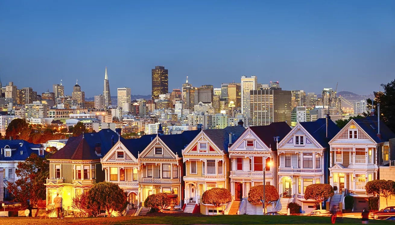 View of homes in the foreground and tall buildings in the in the distance.