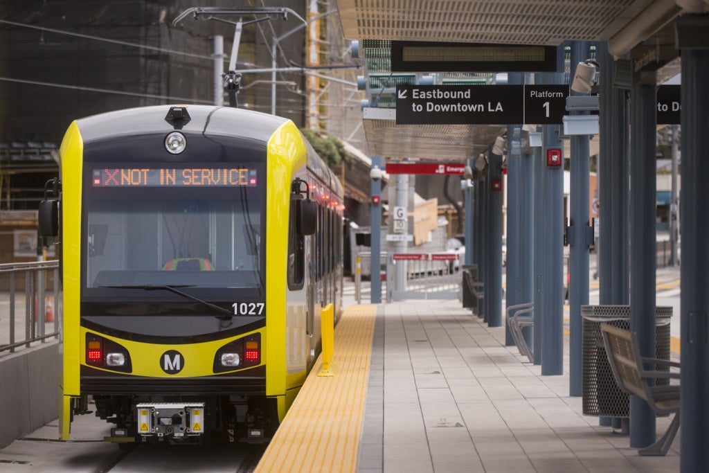 A front view of the new metro line train stopped at the passenger loading dock.