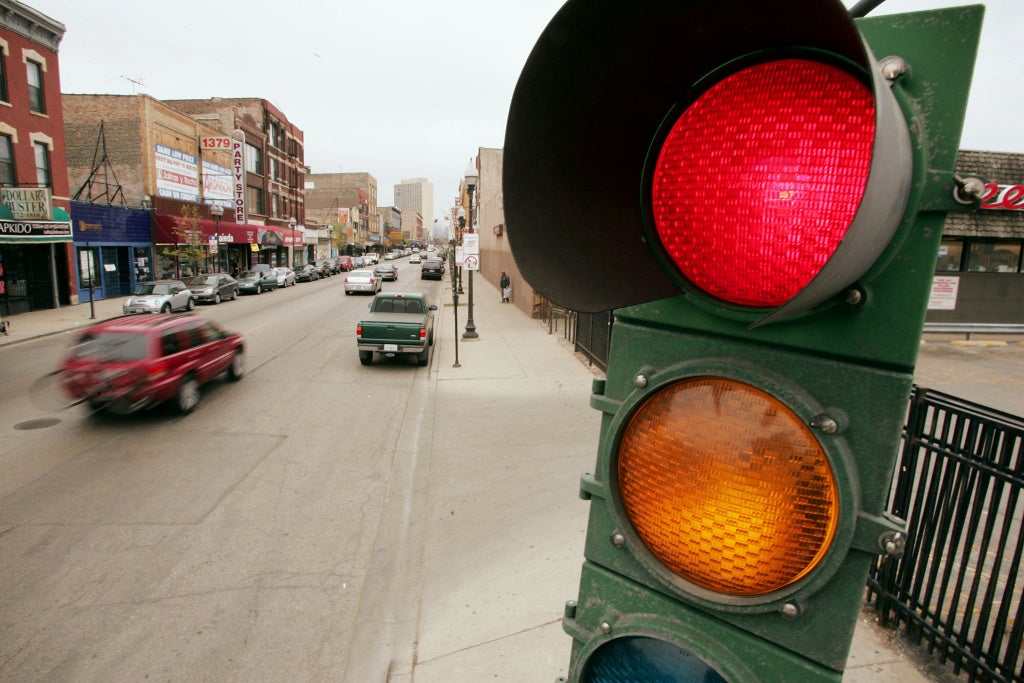 A traffic light controls the flow of vehicles and pedestrians near downtown Chicago, Illinois.