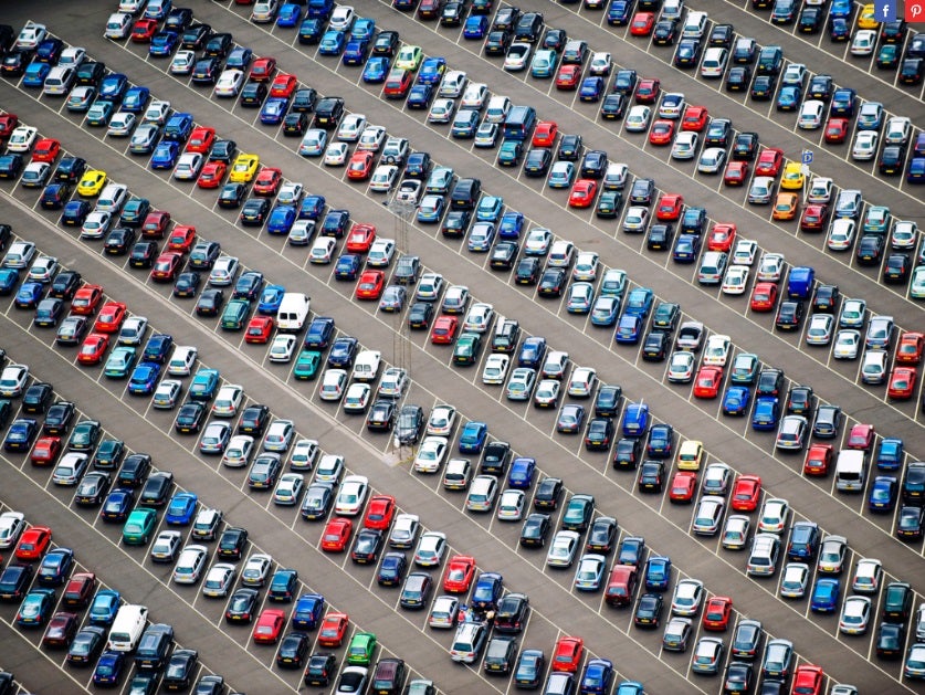 A parking lot completely full of cars.