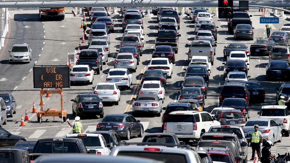 Traffic streams in to the parking lot of Dodger Stadium on Oct. 10.
