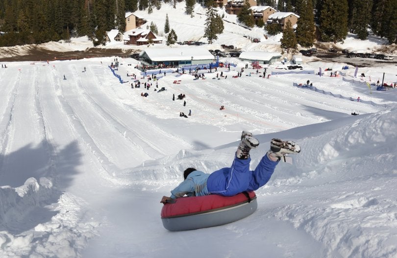 An intrepid tuber heads head-first down the chute at Leland Snowplay in Leland Meadows, near Pinecrest.