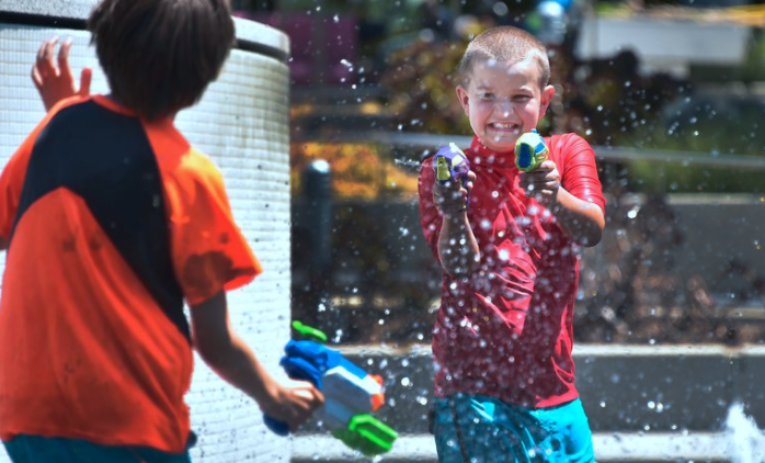 Children cooled off at a splash park in downtown Los Angeles on Monday.