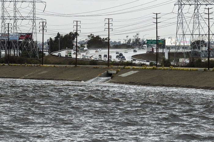 A water reservoir next to a freeway. 