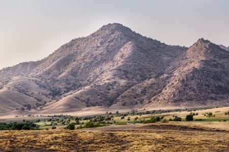 a view of a mountain and open land