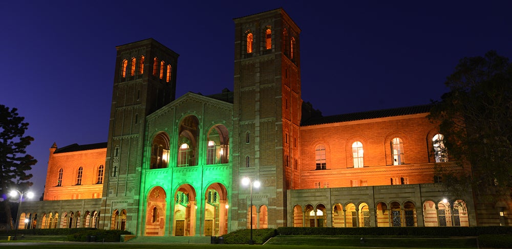 Royce Hall illuminated in green