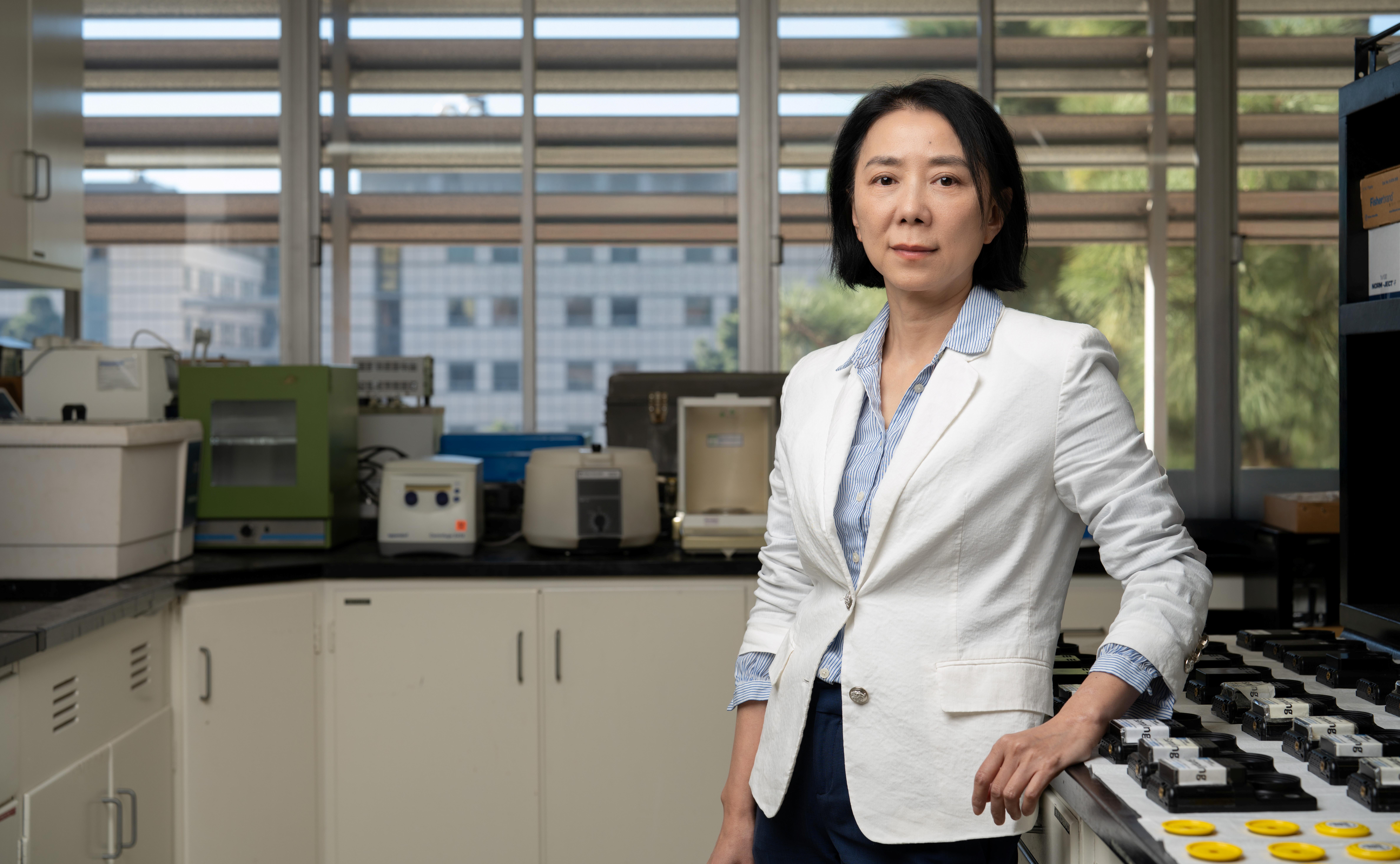 A woman standing in a laboratory.