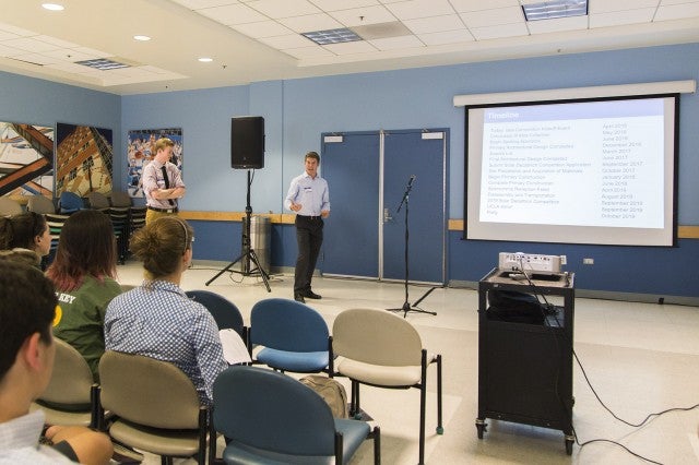 A group of people observing a presentation.
