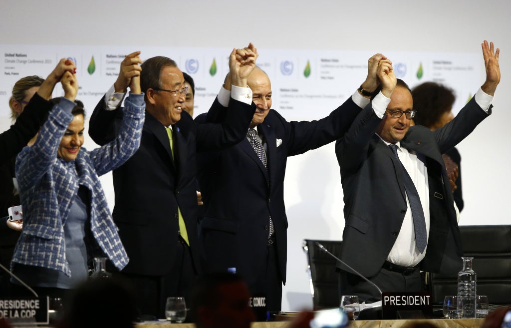 From right, French President Francois Hollande; French foreign minister and president of the COP21, Laurent Fabius; United Nations Secretary General Ban ki-Moon; and United Nations climate chief Christiana Figueres hold hands after the conference on climate change, in Le Bourget, France—north of Paris—on Saturday, Dec.12, 2015.