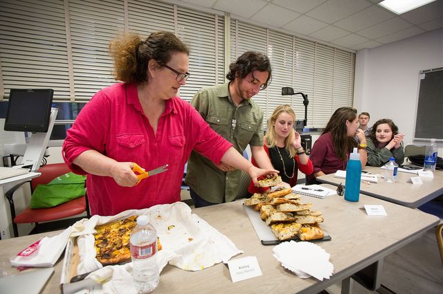 Evan Kleiman’s students take a break from serious discussions about food issues to enjoy a focaccia pizza she made.