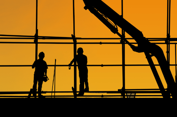 Outline of construction workers during sunset