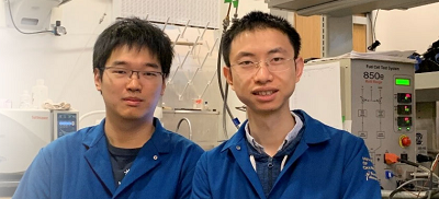 UCLA doctoral student Zeyan Liu (left) and UCLA postdoctoral scholar Zipeng Zhao (right) and sitting next to the fuel cell testing station