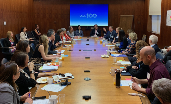 Many people sitting and discussing around a table