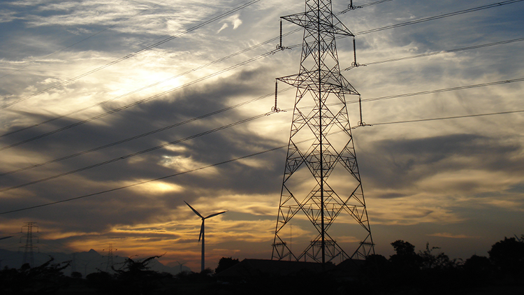 Sunset with power lines and structure in the foreground