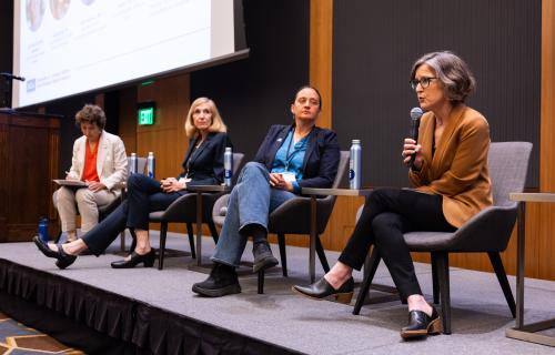 A panel of people sitting on a stage.