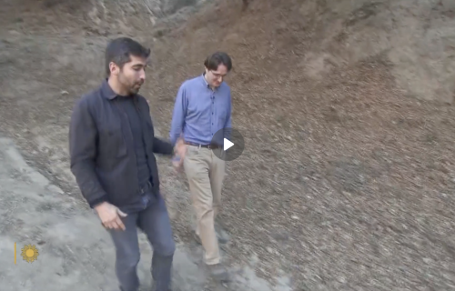 Two men walking in the mountains.
