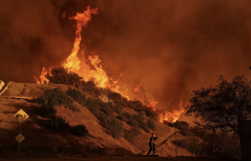 A fire burns on a mountain ridge.