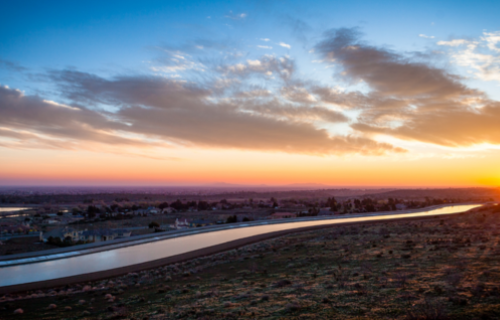 An overhead view of an aqueduct at sunset.