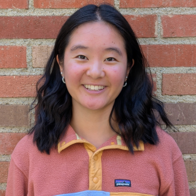 A young woman smiling at the camera.