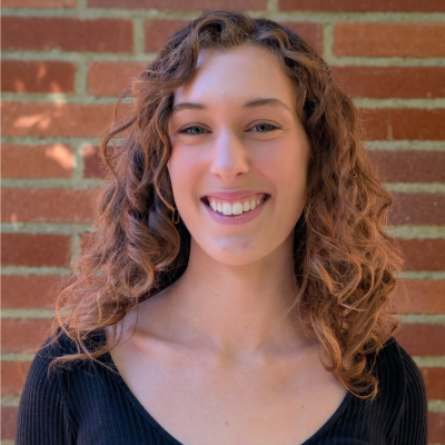 A young woman smiling at the camera.