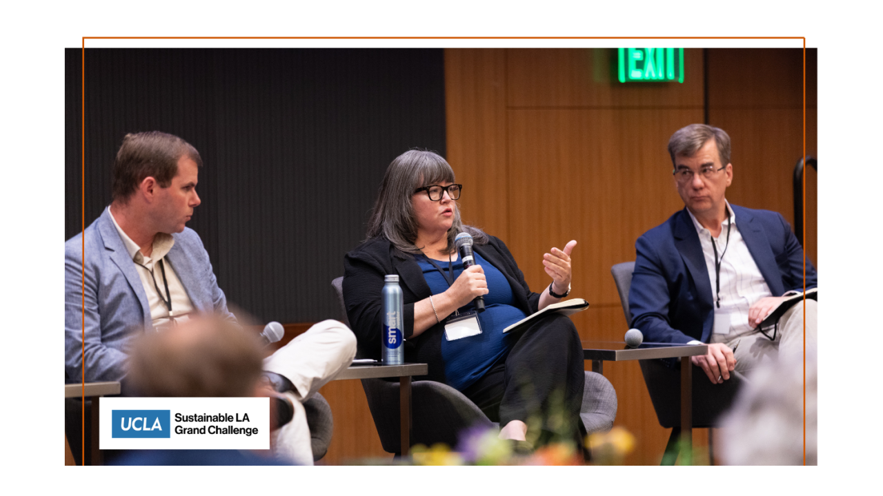 Three panelists on stage.
