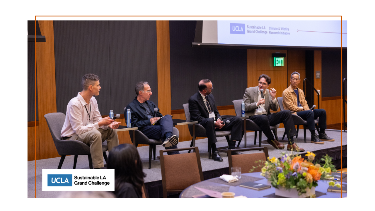 A panel of people sitting on stage.