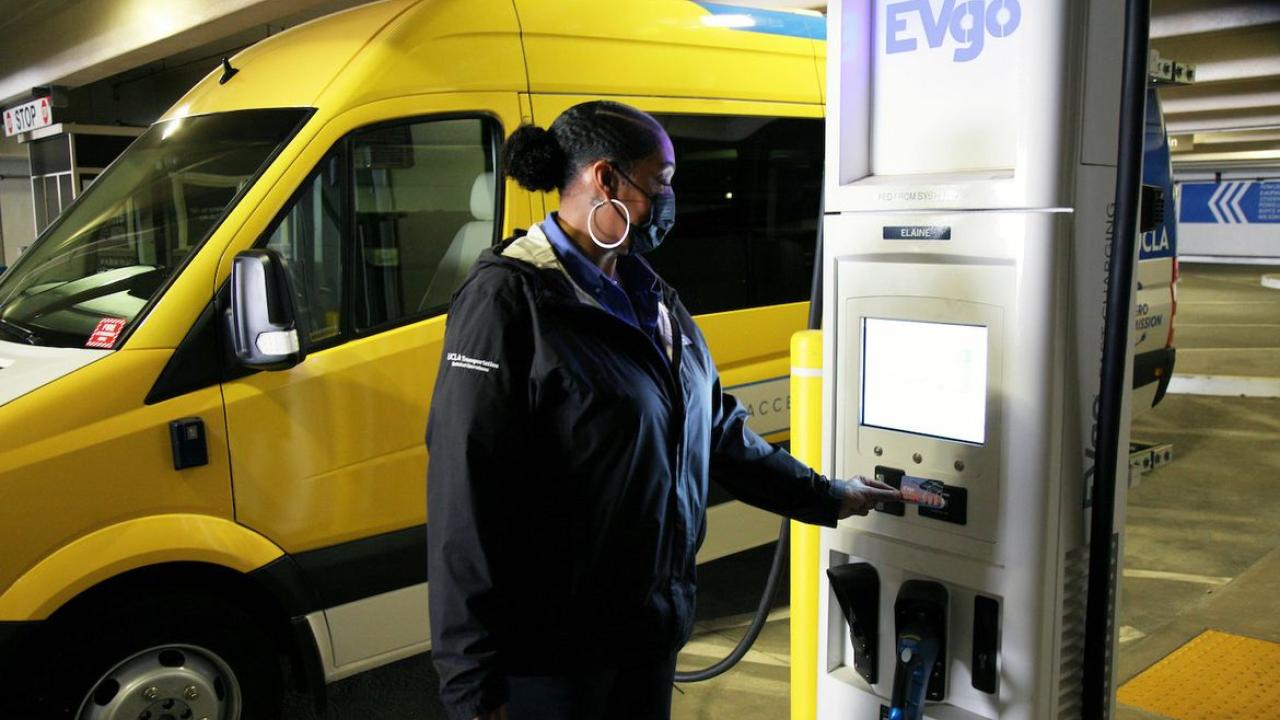 woman by EV charging station