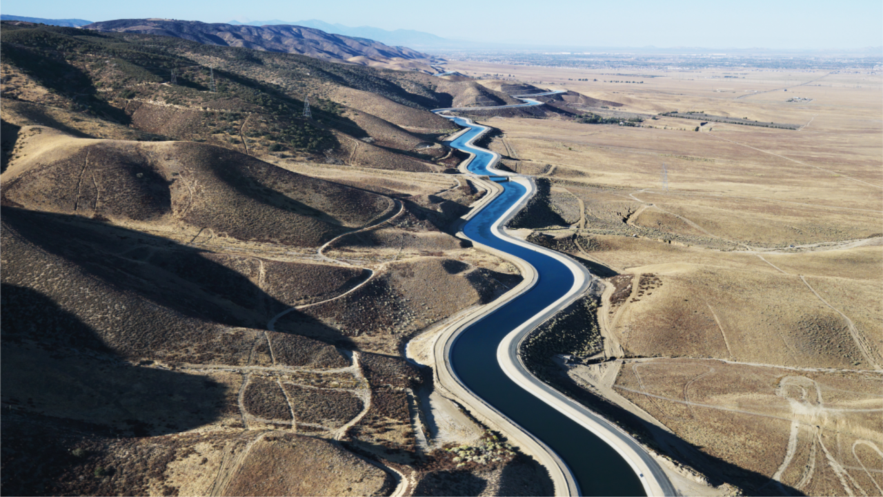 An overhead view of an aqueduct in the desert.