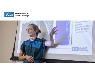 A young woman gestures at a slide projected behind her.