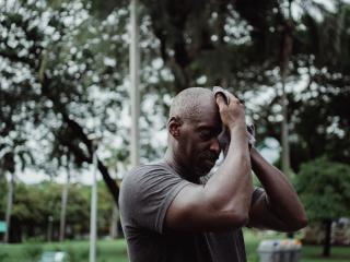 Man wiping off his eyebrow in the heat
